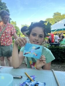 girl holding art card